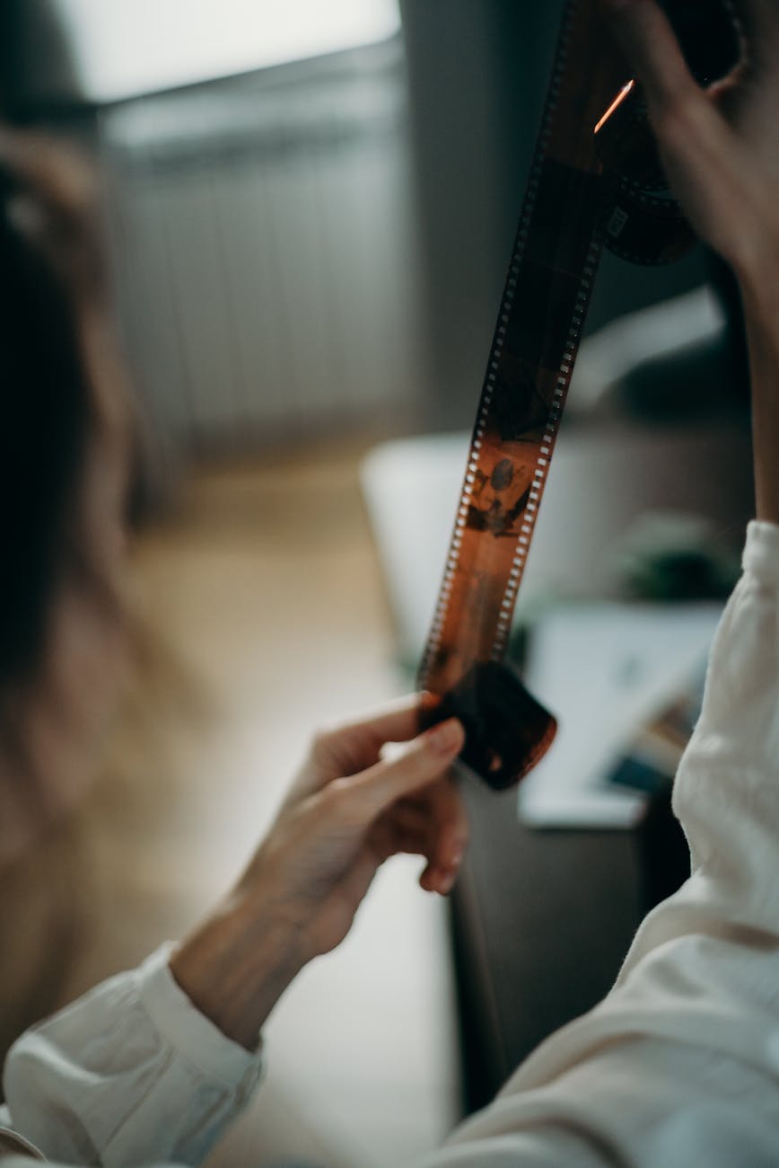 person holding negative film